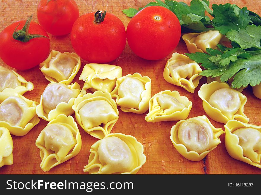 Prepare tortellini stuffed with meat sauce with tomato and parsley. Prepare tortellini stuffed with meat sauce with tomato and parsley