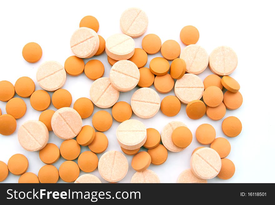 Orange and Pink medicine pills isolated on white. Orange and Pink medicine pills isolated on white