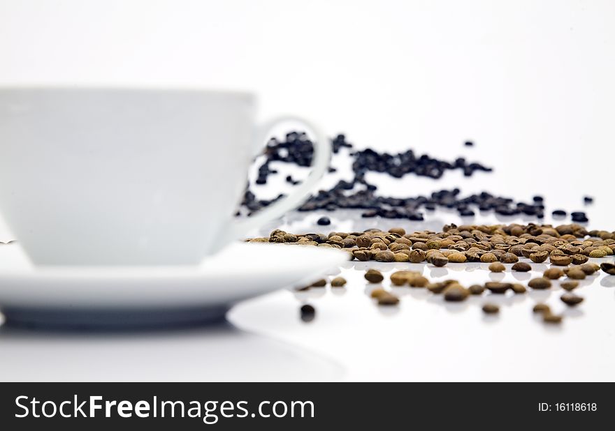 Coffee beans with cup on table. Coffee beans with cup on table