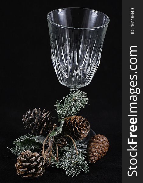 A glass with a branch of pine needles