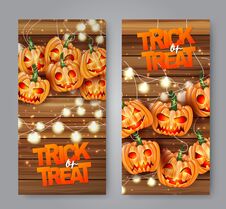 Halloween Trick Or Treat Flyer Set With Pumpkin Creepy Faces And Lights Garland Over Wooden Board Background. Royalty Free Stock Photo