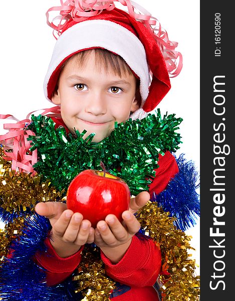 Cute small boy in santa's hat with apple in hands