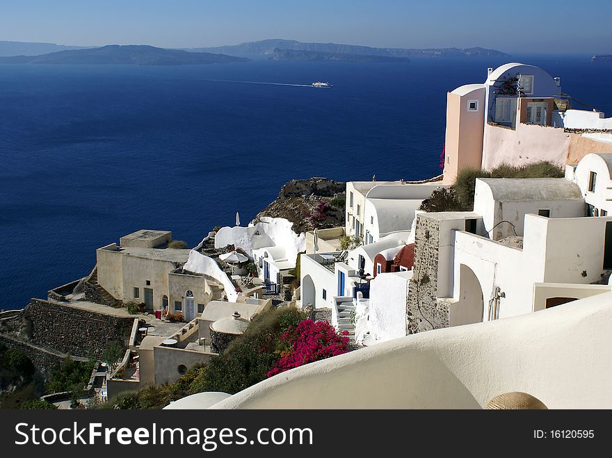 Panoramic view over the picturesque village of Oia (Santorini, Greece). Panoramic view over the picturesque village of Oia (Santorini, Greece).