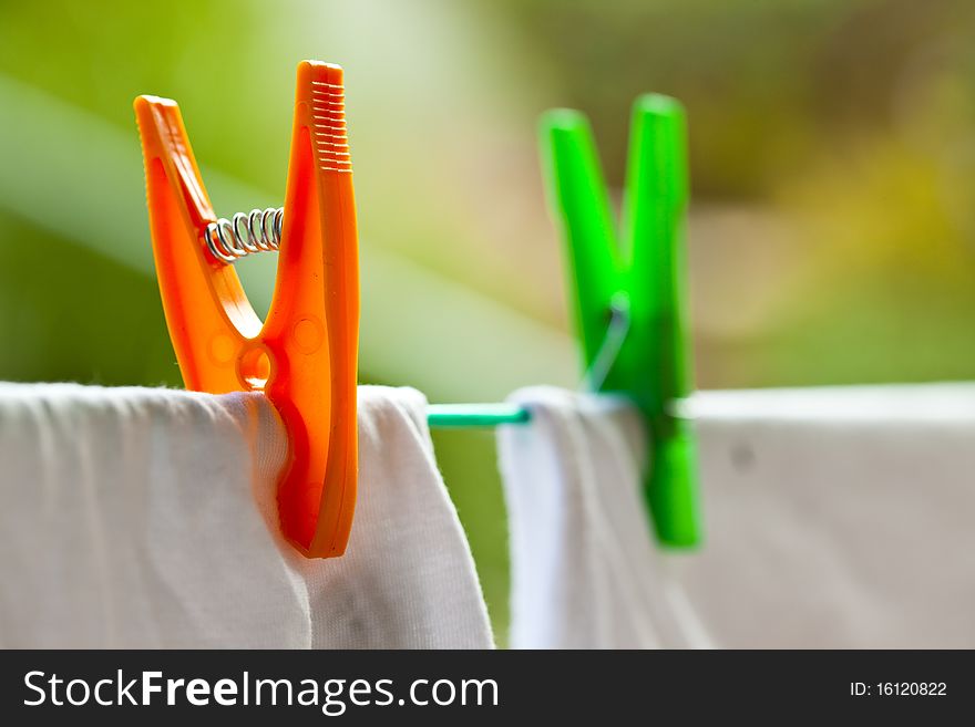 Coloured pins on clothes line in the garden