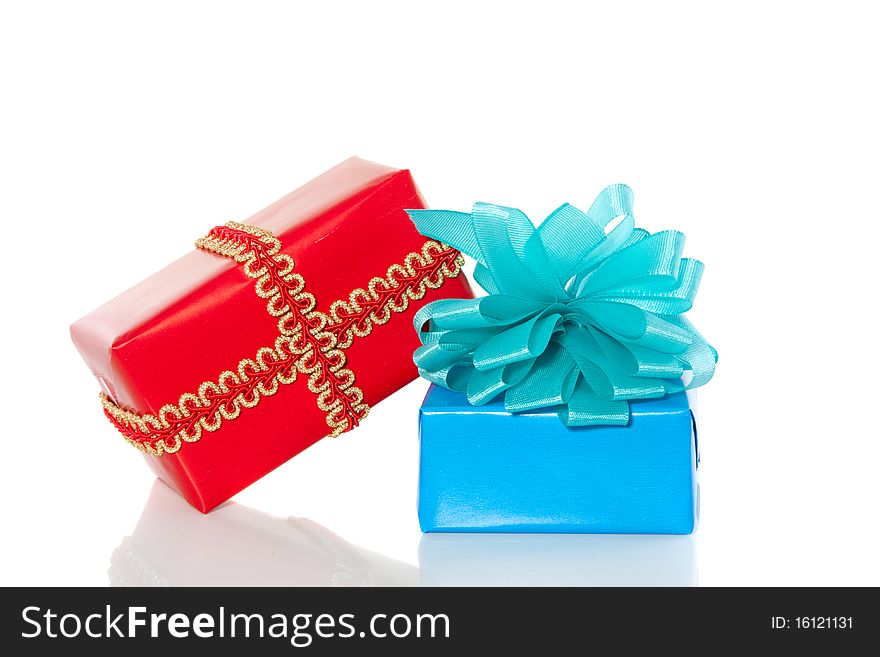 A red and a blue gift with a ribbon and a bow isolated over white