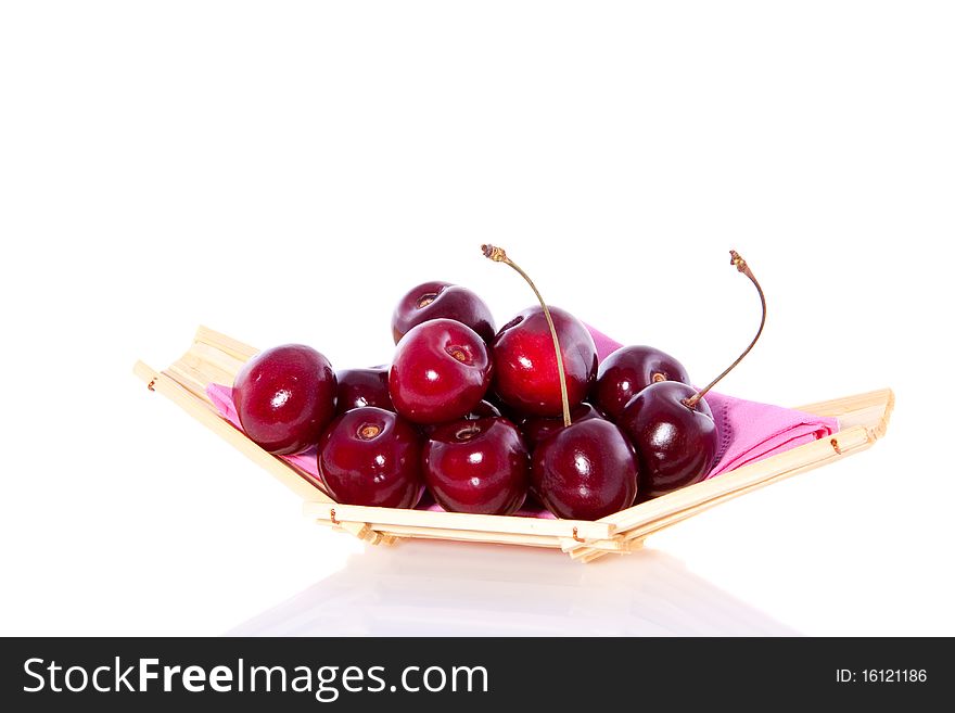 Sweet cherries on a wooden serving dish isolated on white background. Sweet cherries on a wooden serving dish isolated on white background
