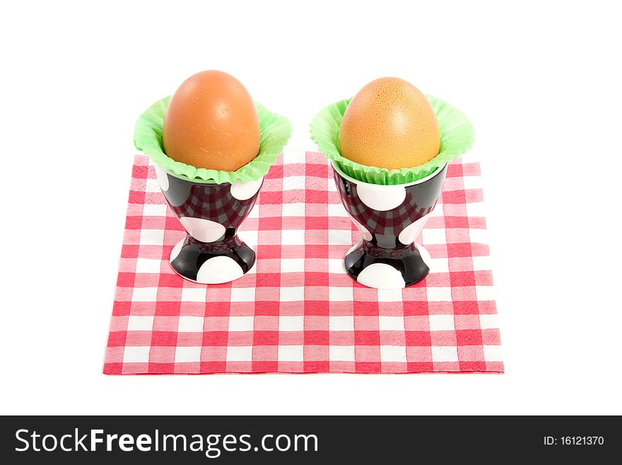 Two eggs in dotted eggshells  on a red white checkered napkin