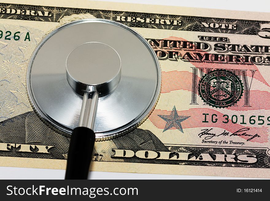 The American money (dollars) on which the stethoscope lies. The American money (dollars) on which the stethoscope lies
