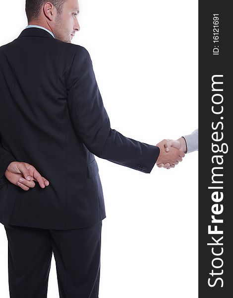 Businessman shaking hands, holding fingers crossed