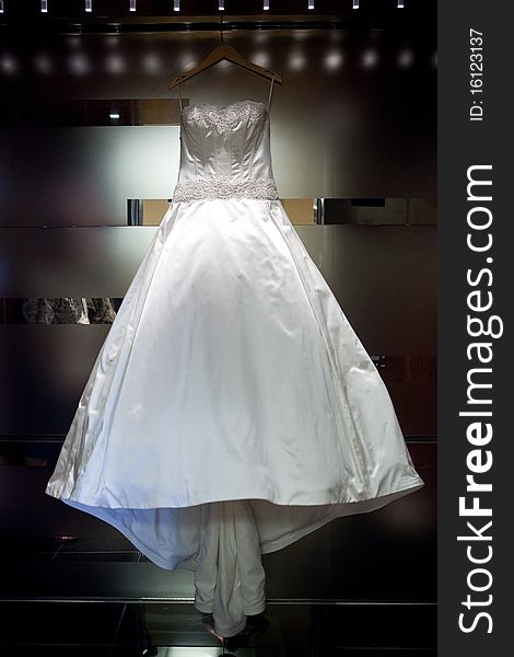 White satin Wedding Dress Hanging on Wall