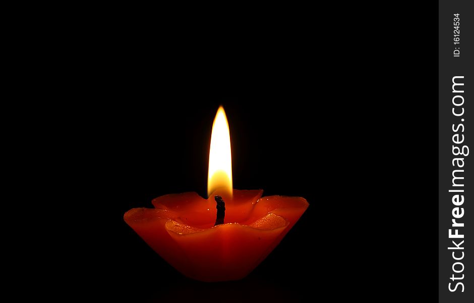 Red candle light in dark background