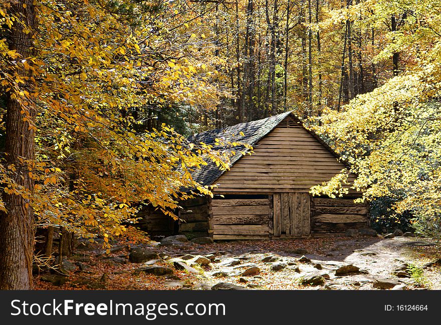 Rustic barn made of plank wood nested deep in the mountains surrounded by colorful autumn foliage. Rustic barn made of plank wood nested deep in the mountains surrounded by colorful autumn foliage