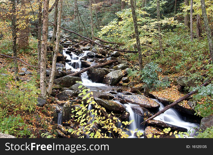Waterfall nestled deep in the Smokey mountains surrounded by fall colors. Waterfall nestled deep in the Smokey mountains surrounded by fall colors