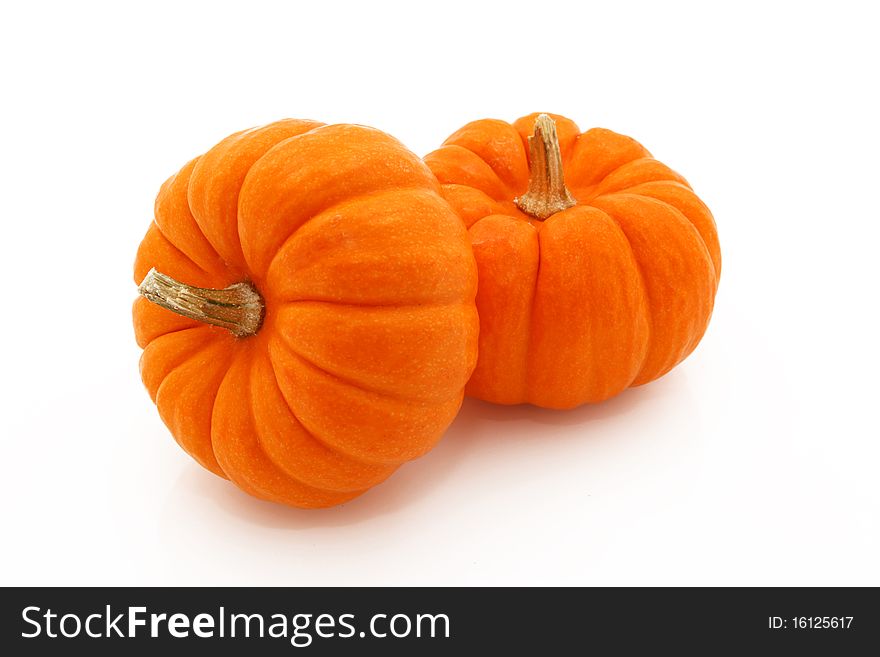 Stacked Orange Gourds Shot On White Background. Stacked Orange Gourds Shot On White Background