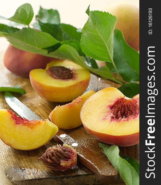 Fresh peaches on board with knife