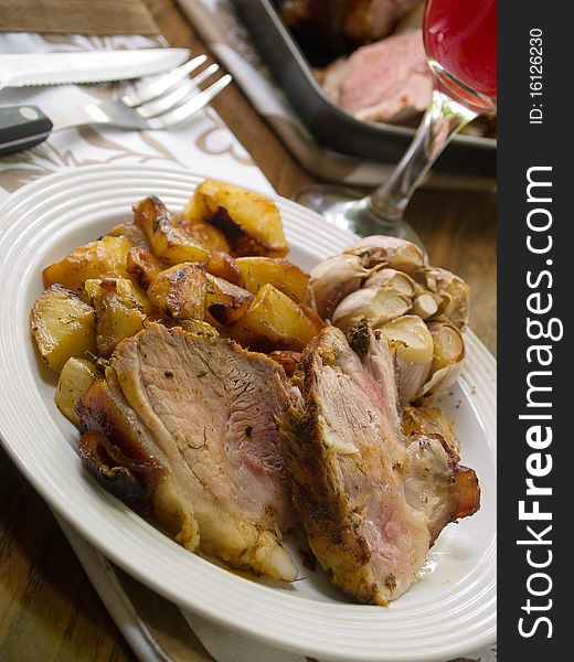 Delicious roasted pork knuckle with baked potatoes. Delicious roasted pork knuckle with baked potatoes