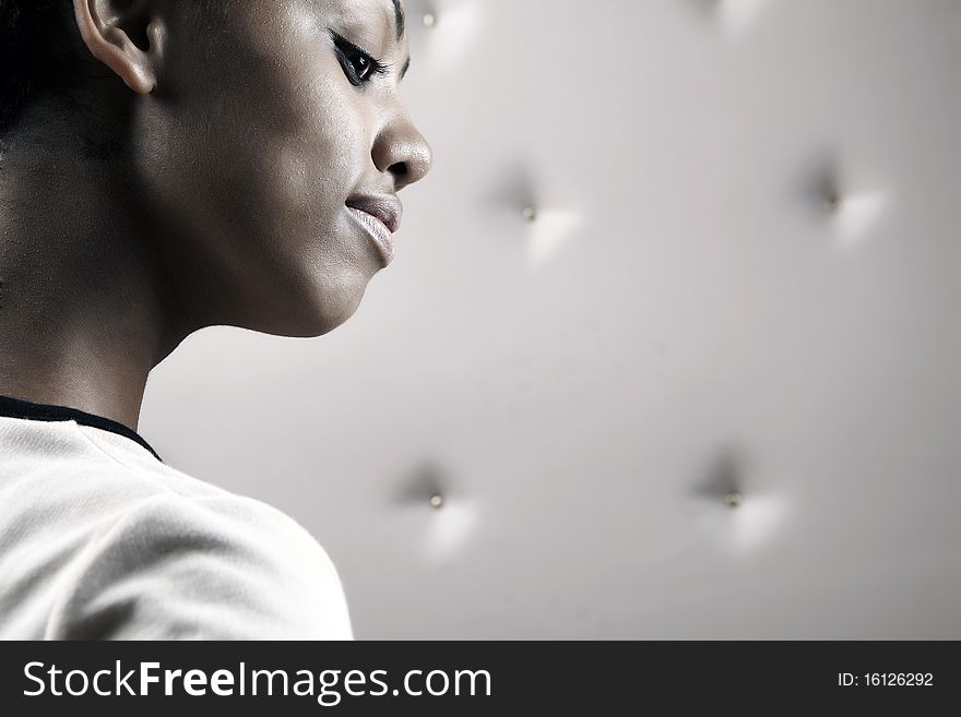 Close-up portrait of Beautiful African woman pose on a beige leather background.
