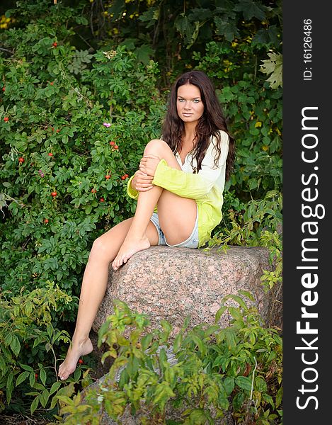 Woman sitting on the stones