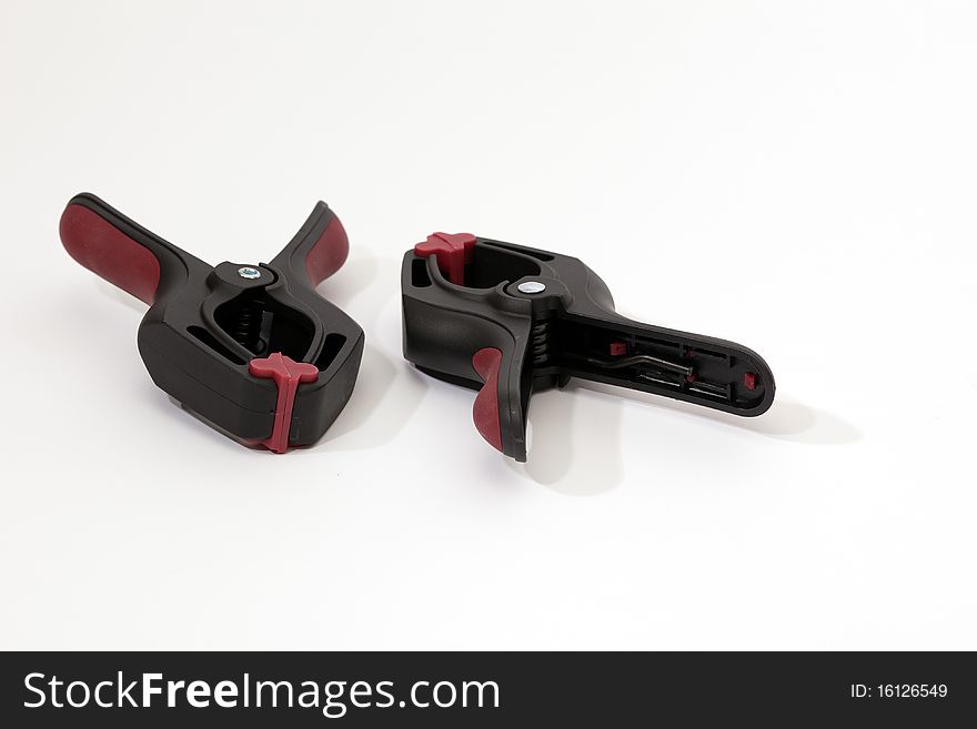 A set of spring clamps made of plastic.