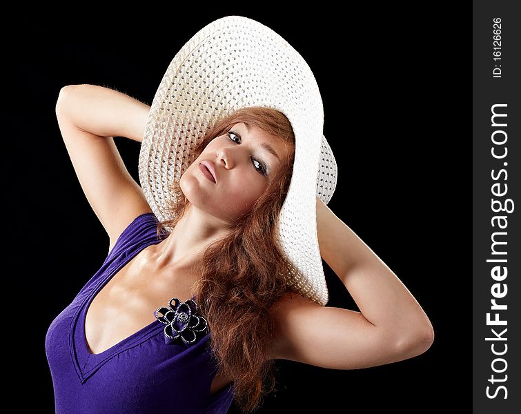 Girl in sexy dress with a hat isolated on black background