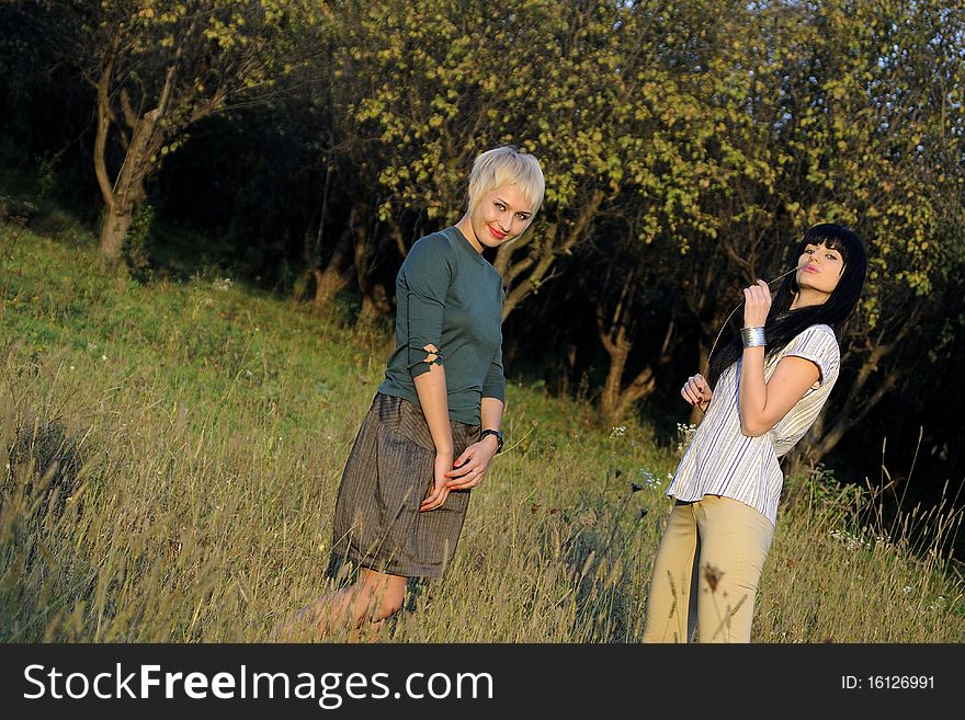 Two young woman expressing relationship in fall season. Two young woman expressing relationship in fall season