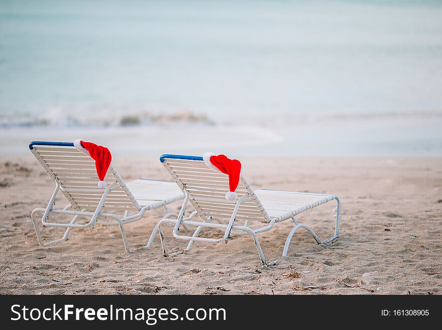 Closeup santa hat on chair on tropical white beach