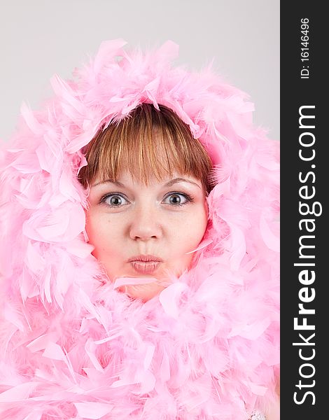 The woman in pink feathers, is similar to a chicken, kisses. The woman in pink feathers, is similar to a chicken, kisses