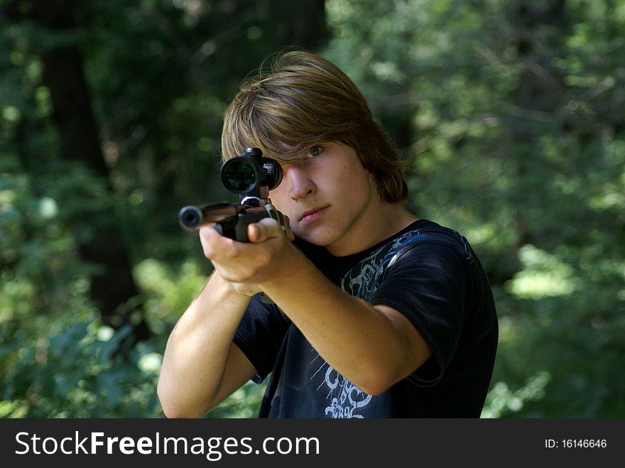 Fifteen years old boy with a gun in the forest. Fifteen years old boy with a gun in the forest