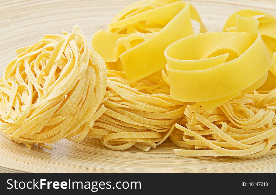 Raw Italian pasta on plate. Raw Italian pasta on plate