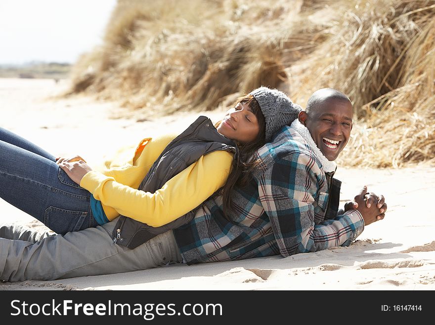 Romantic Young Couple On Winter Beach Smiling.