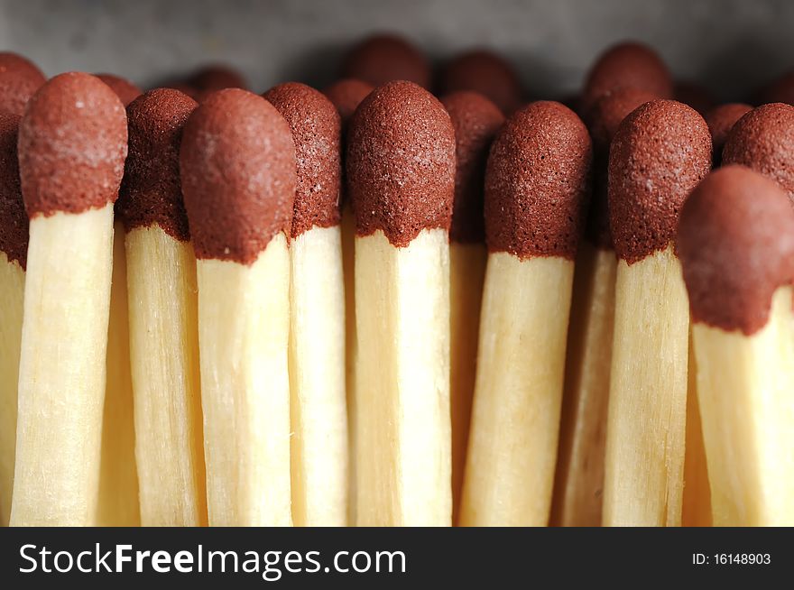 A close up photo of a pile of matchsticks.