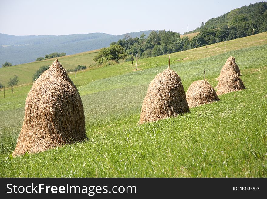 Hay piles on the Bieszczady mountains field. Hay piles on the Bieszczady mountains field