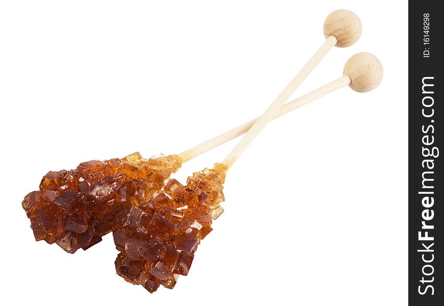 Brown amber sugar crystal on wood stick,isolated on white with clipping path