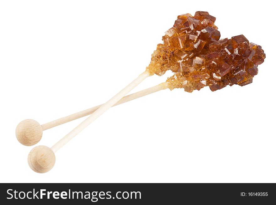 Brown amber sugar crystal on wood stick,isolated on white with clipping path