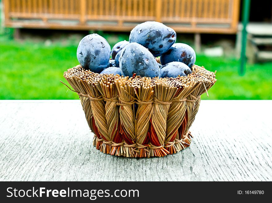 Plums in a wicker basket