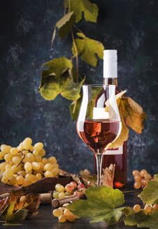Rose Wine At Wine Tasting Concept. Gray Background With Grape And Leaves. Pink Wine In Wineglass. Copy Space Royalty Free Stock Images Rose Wine At Wine Tasting Concept. Gray Background With Grape And Leaves. Pink Wine In Wineglass. Copy Space Royalty Free Stock Images