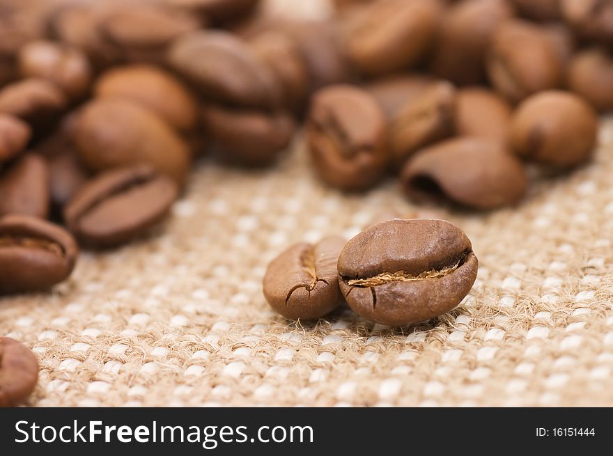 Brown coffee grains on a sacking close up