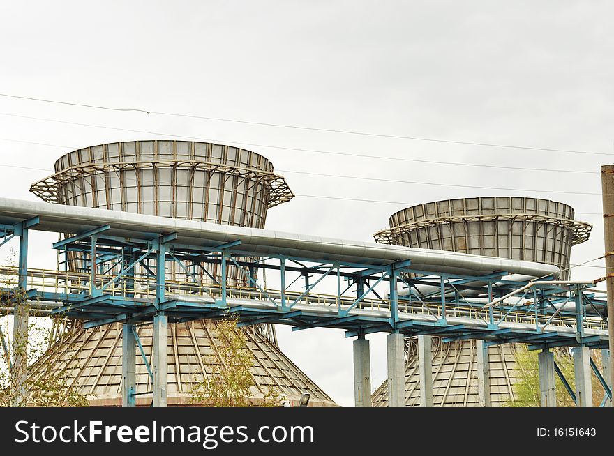 Tube on the background of large pipes; an industrial district; horizontal. Tube on the background of large pipes; an industrial district; horizontal