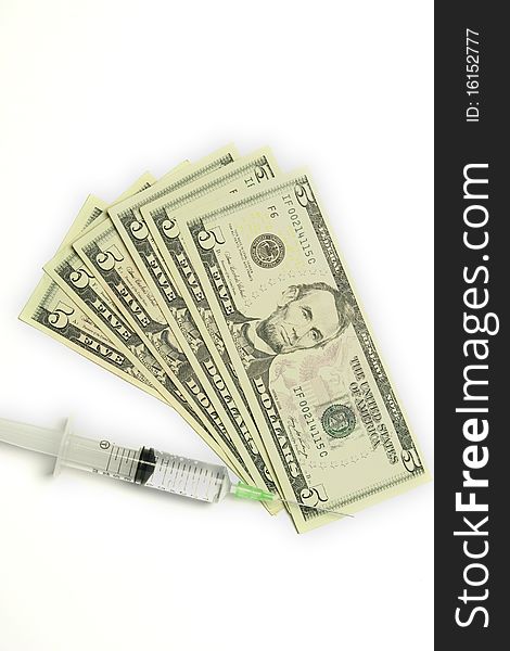 Five dollar bills and syringe isolated on white background