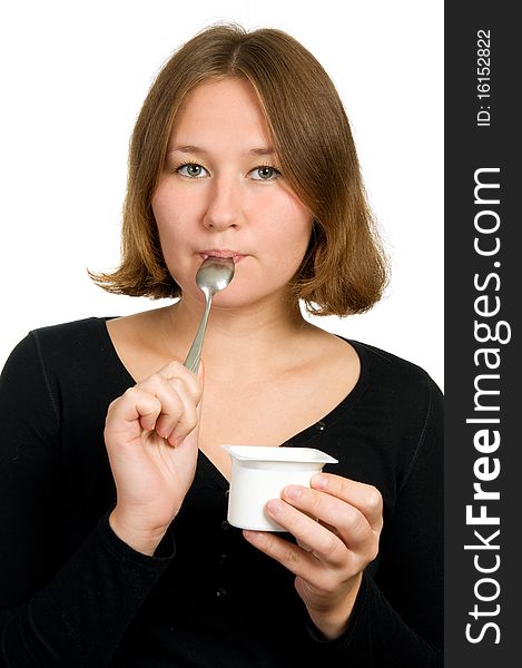 Woman is licking spoon over white. Woman is licking spoon over white