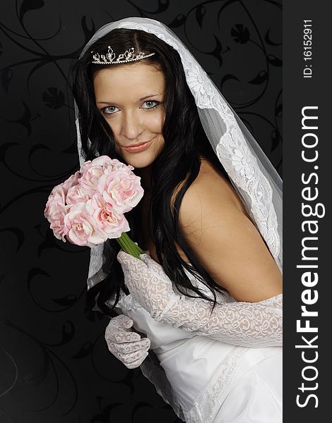 Portrait of beautiful happy bride in a wedding dress on black background studio shot. Portrait of beautiful happy bride in a wedding dress on black background studio shot