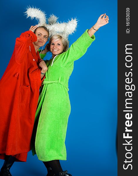 Two happy friends girl in bathrobes