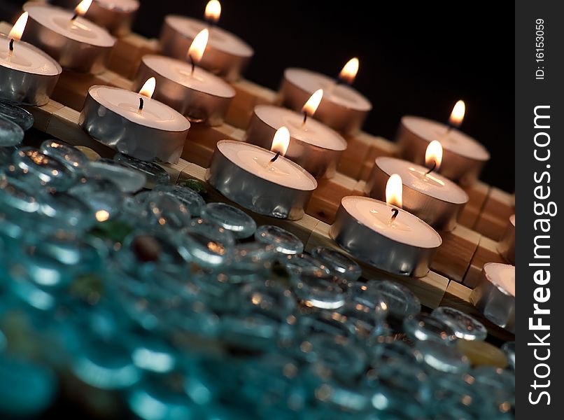 Rows of Lit Candles with Out of Focus Glass Beads. Rows of Lit Candles with Out of Focus Glass Beads