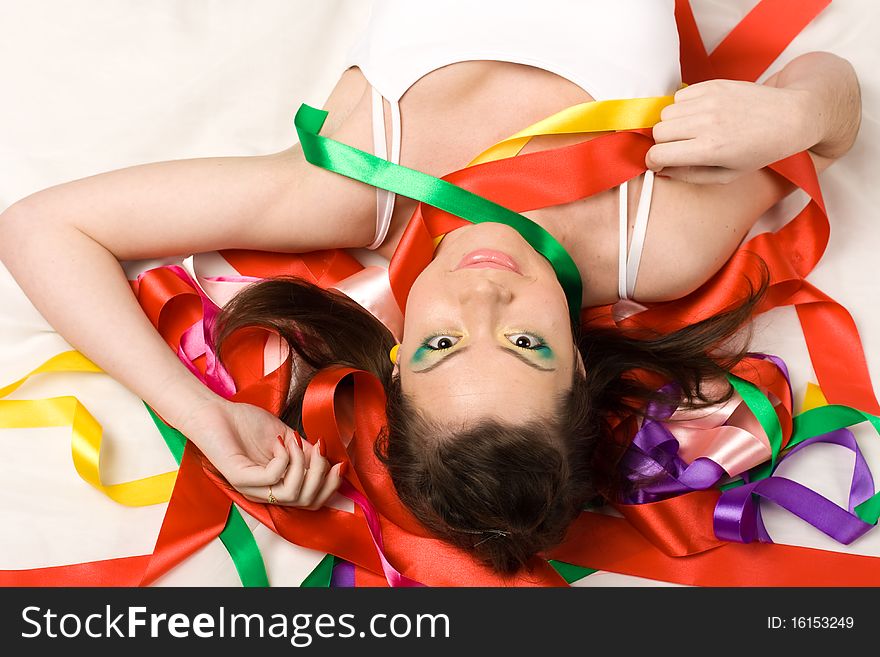 girl with colourful ribbons in studio on red background. girl with colourful ribbons in studio on red background