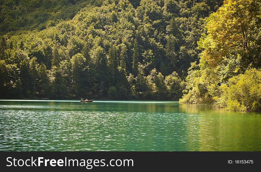 A romantic lake scene with a couple in a row boat