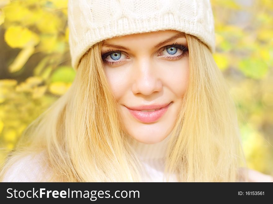 Portrait of a beautiful girl on a background of autumn