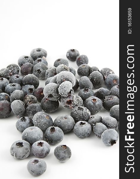 A bunch of frozen blueberries on white background.