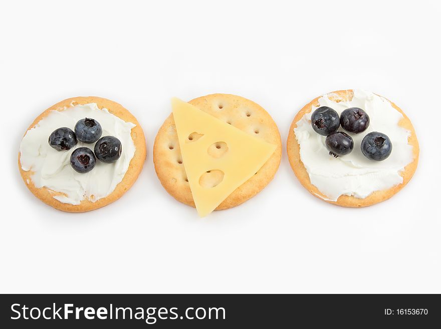 Three round crackers, snacks with cheese and fruit