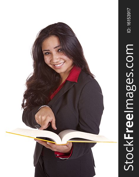 A woman is holding a book pointing and looking up. A woman is holding a book pointing and looking up