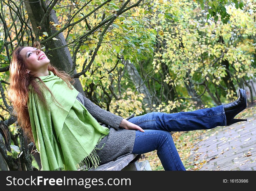 Young girl relaxing in autumn park. Young girl relaxing in autumn park